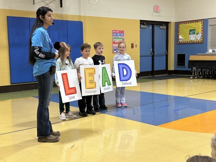 students hold posters that read Lead