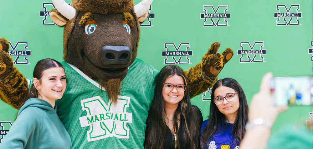 Hurricane High School Students take a photo with Marshall University mascot, Marco, during Marshall's Direct Admit event.