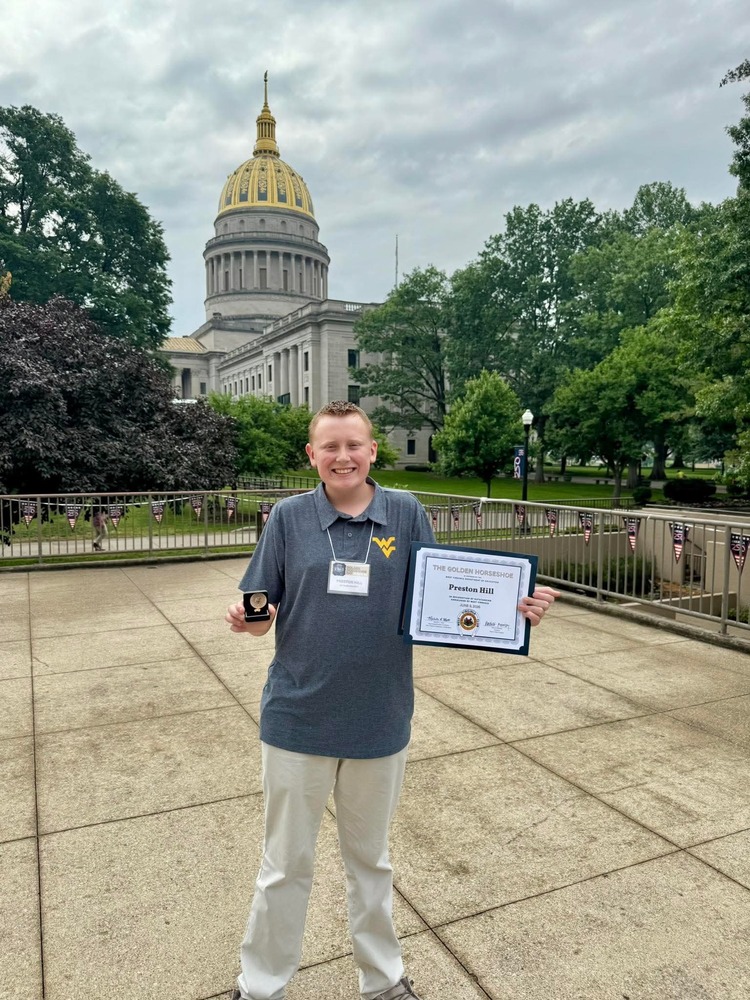 HMS student Preston Hill with his Golden Horseshoe Award and certificate