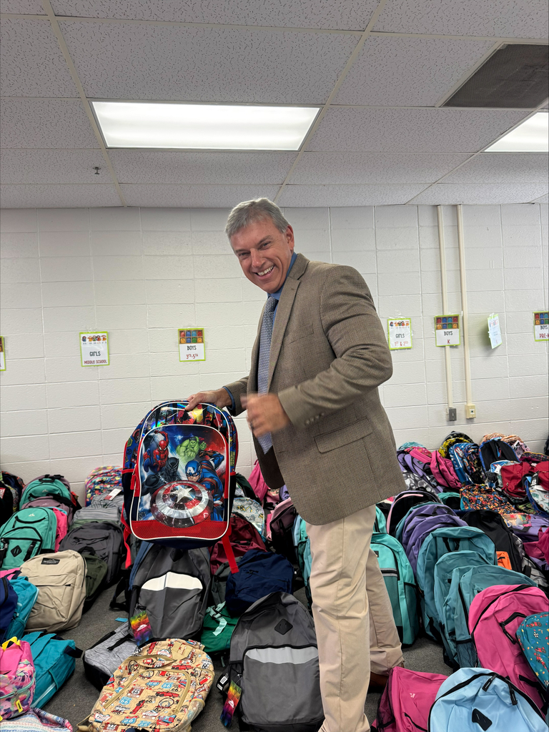 Mr. McGrew finds student backpack for Back to School Blast
