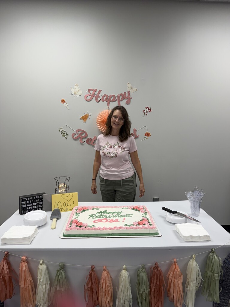 Lisa King in front of her retirement cake 