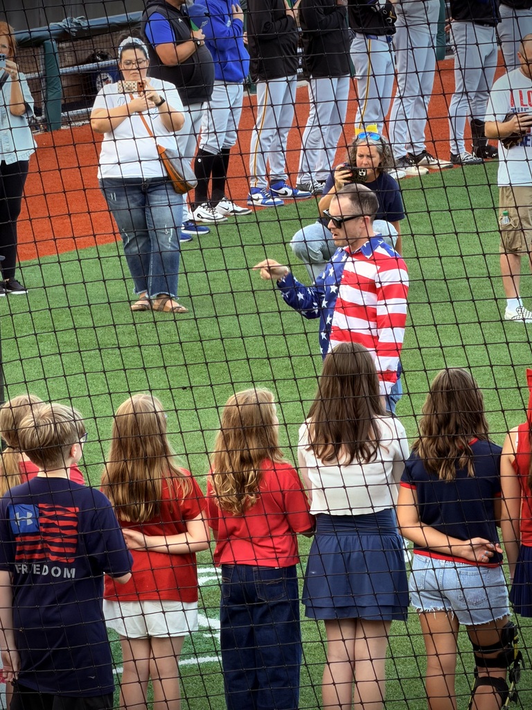 Mr. Skiles leads choir in National Anthem 