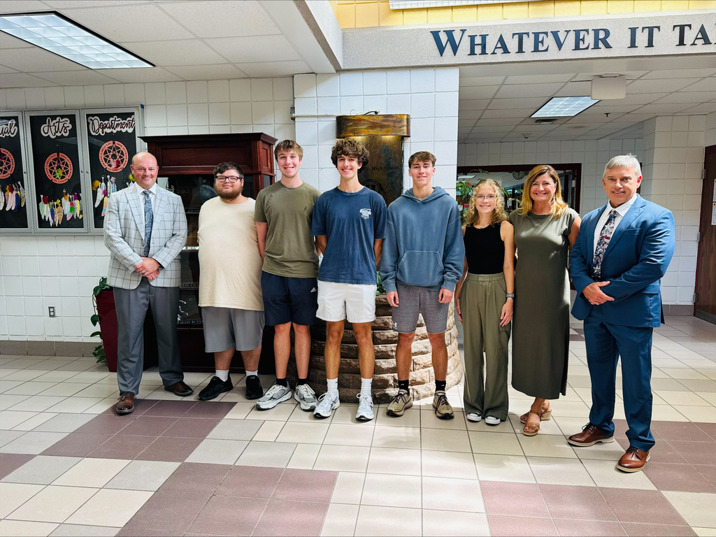 Mr. McGrew, Mr. McClanahan and Ms. Schoolcraft stand with National Merit Semi Finalist 
