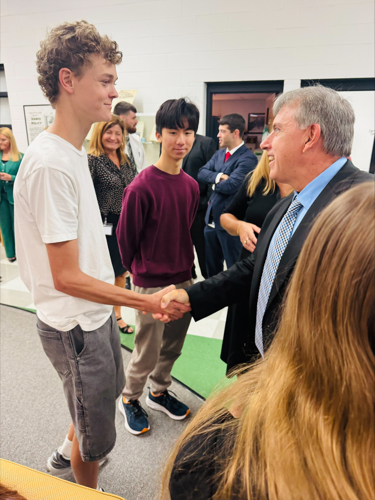 Mr. McGrew congratulates WHS student. 