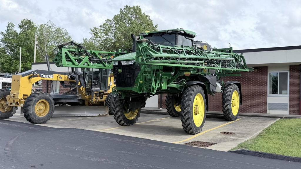 Field sprayer and road grader