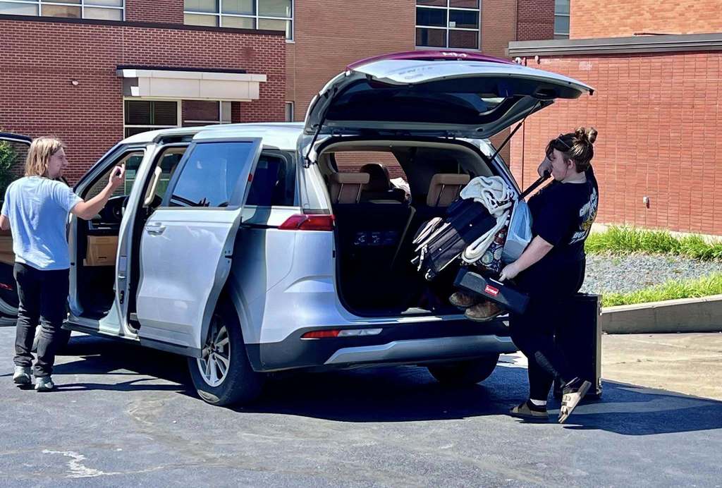 Kelly loading up luggage in van
