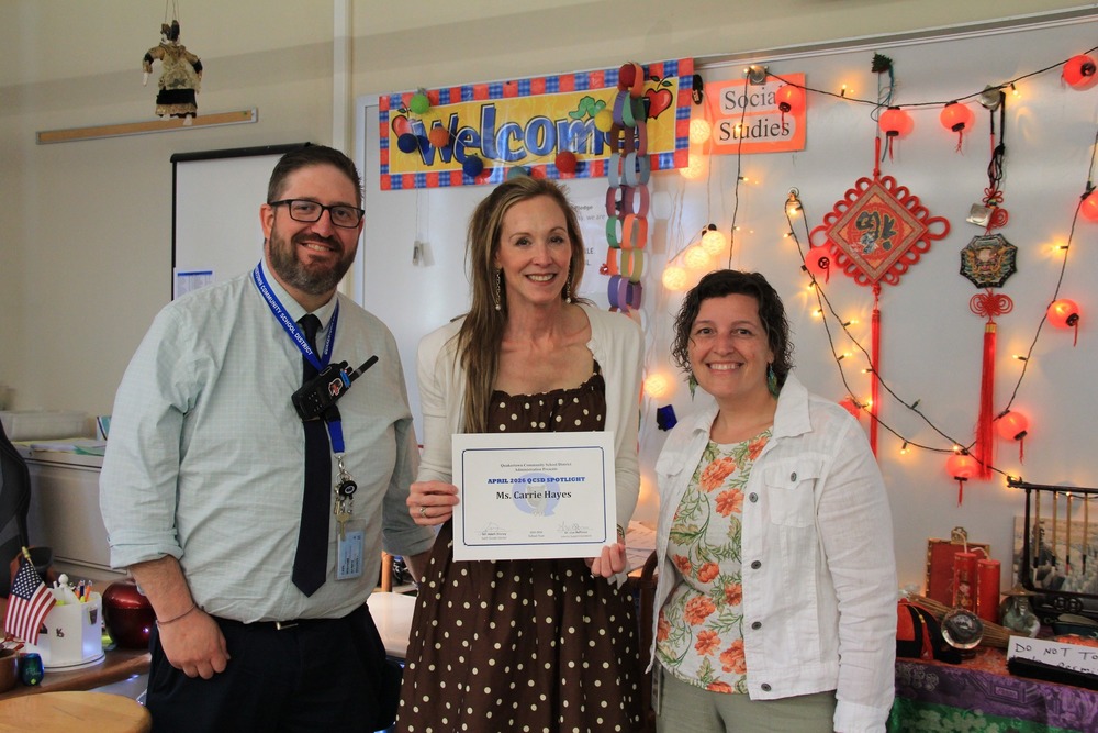 Each month, one of our outstanding QCSD staff members is recognized for their exceptional contributions to their students, colleagues, and school community.   For April, we are celebrating Mrs. Carrie Hayes of the Sixth Grade Center! Yesterday, Mr. Dinney and Dr. Hoffman surprised Mrs. Hayes, and read a few of her nominations. Students cheered, applauded, and agreed - Mrs. Hayes is amazing!   Mrs. Hayes is a beloved Social Studies teacher at SGC and received multiple nominations, including:  "When I started teaching Social Studies last year, Mrs. Hayes was so amazing with providing me with resources and helping me with the pacing of the course. Whenever I had a question about materials, content, or curriculum, she was always more than willing to help me. She even provided me with posters and other materials to decorate my room. She is an amazing person, and I consider myself so lucky to have been able to collaborate and work with her."  Thank you, Mrs. Hayes, for bringing joy and energy to your students and colleagues!  To nominate your QCSD Spotlight, click below: https://docs.google.com/forms/d/e/1FAIpQLSdR3LMhDQyS-6r8pQQBeHTlnNxIDGfTXSvVRokf2Wg26DnSzQ/viewform