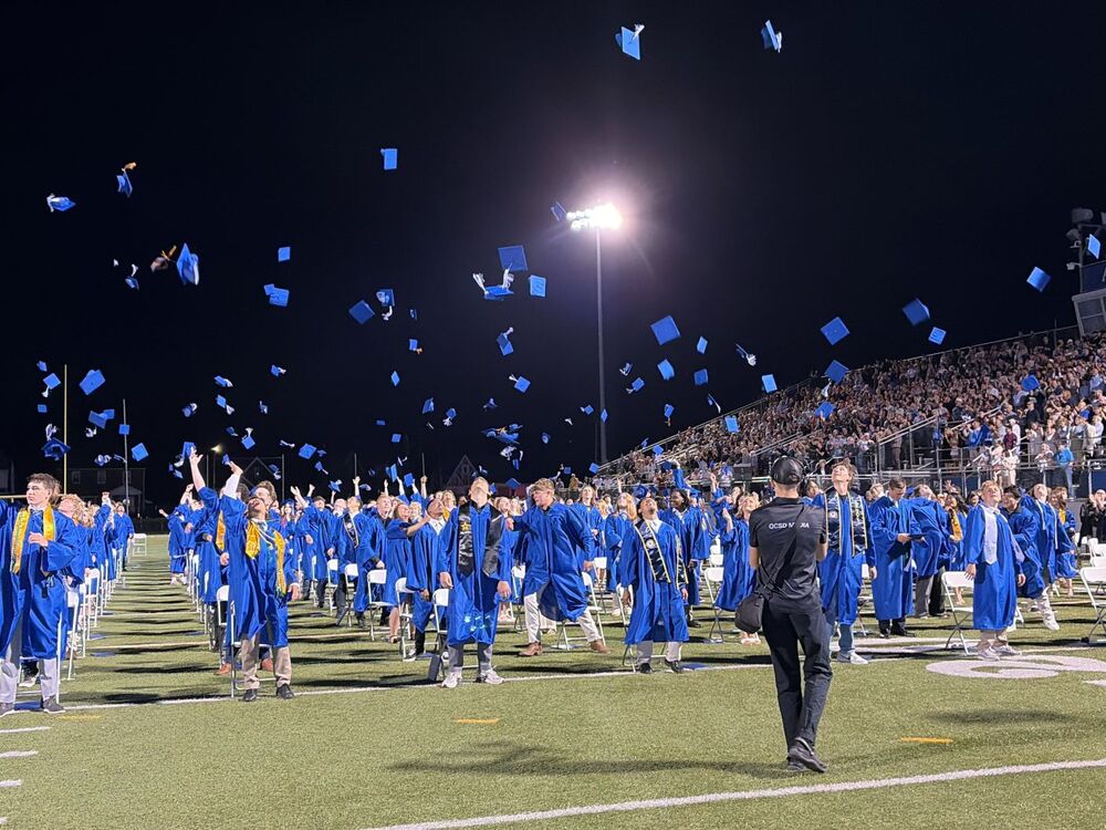 Graduates throwing their caps into the air