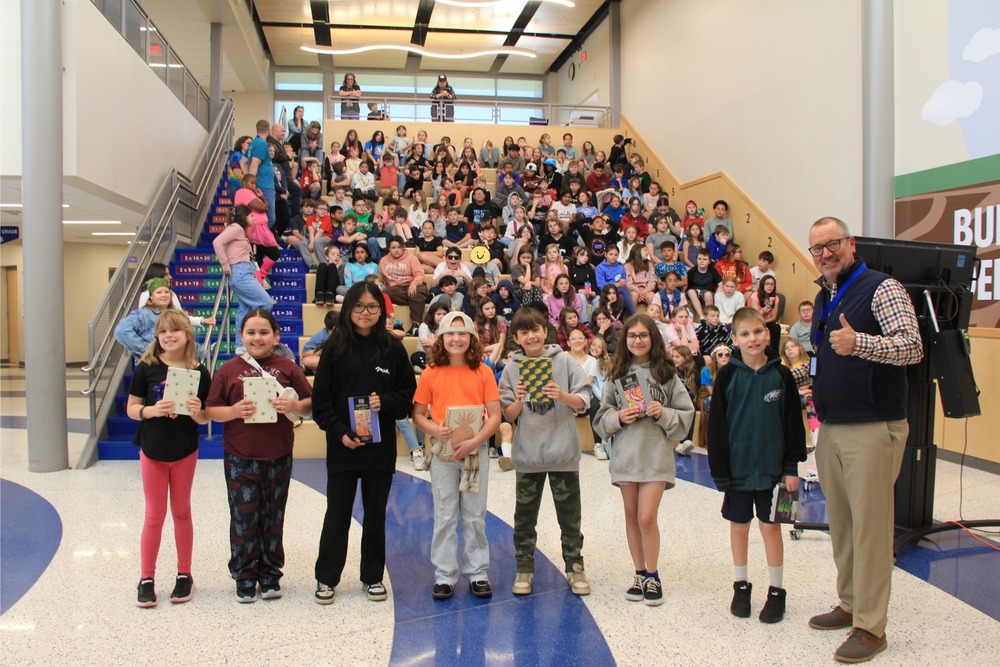 Neidig 4th grade and 5th grade PBIS winners smile with Mr. Godshalk