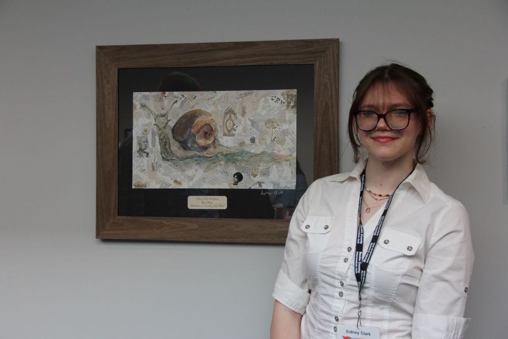 QCHS Junior, Sydney Clark poses with her artwork