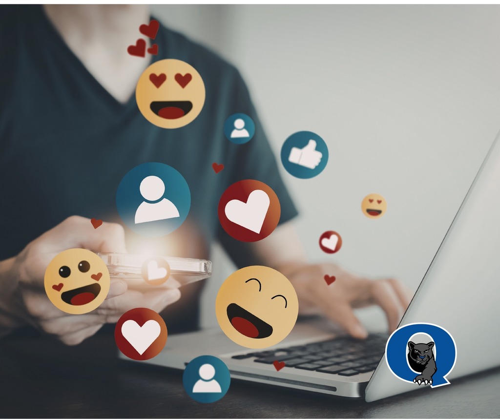 Photo of a person using their phone and laptop with heart and smile emojis