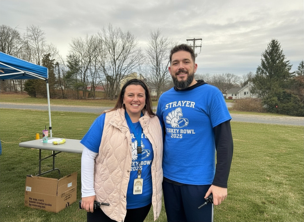 Ms. Maddon and Mr. Smith smile for a photo at the Strayer Turkey Bowl!
