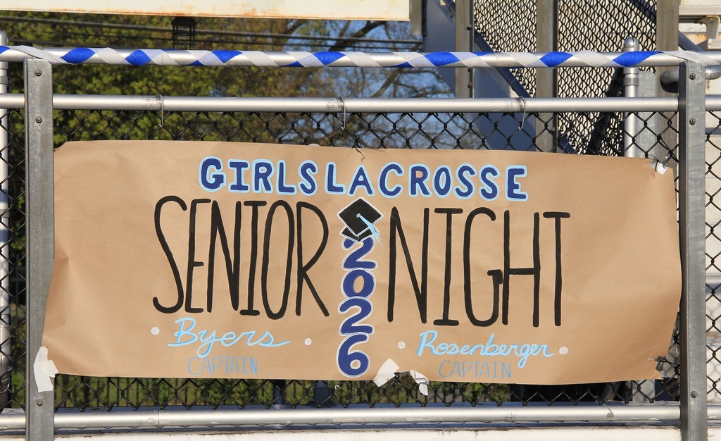A painted sign that says "Girls Lacrosse Senior Night"