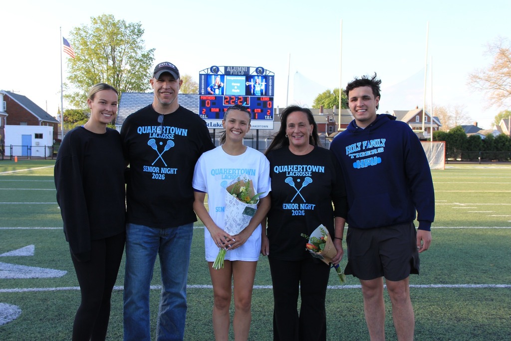 Kasey smiling on the field with her family.