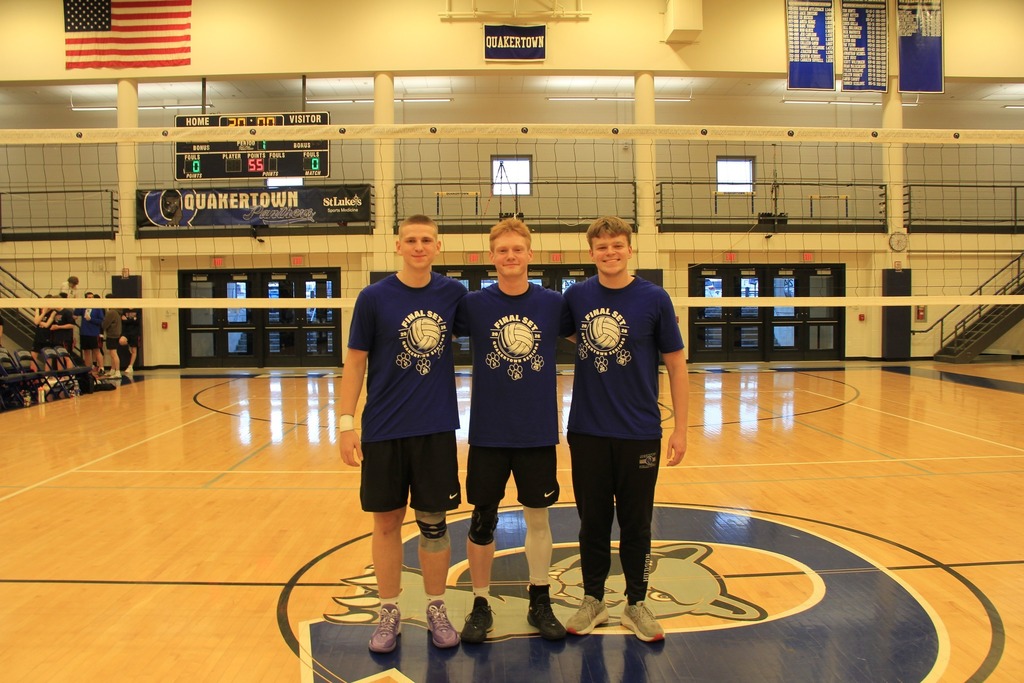 Senior Volleyball players smile for a photo.