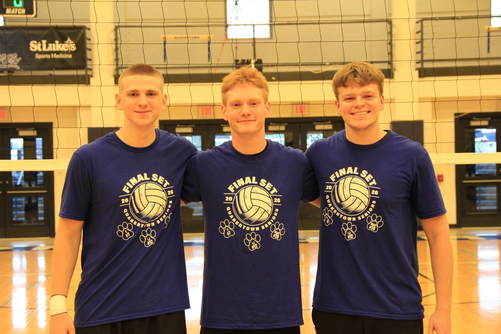 Senior Volleyball players smile for a photo.
