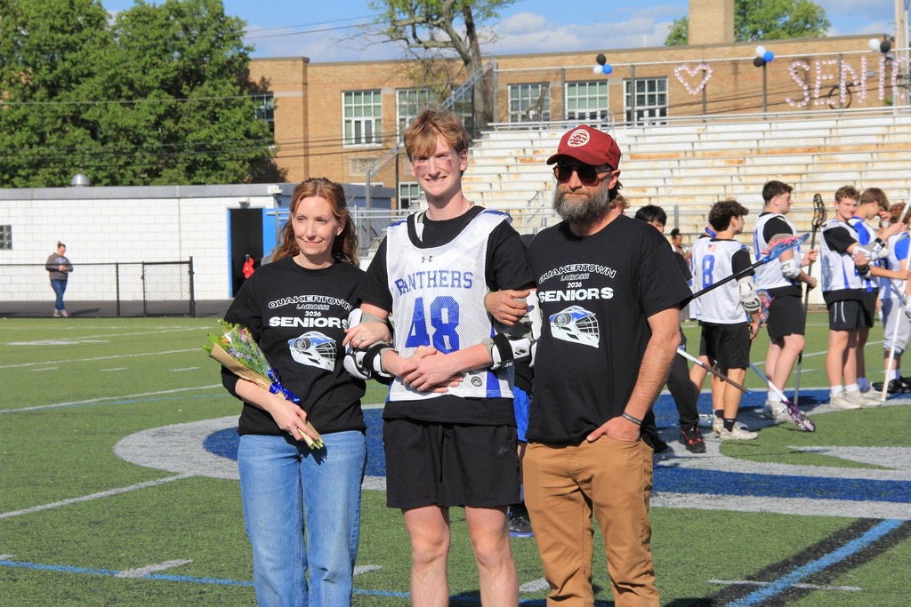 Rowan Painter smiles for a photo with his family on the field.