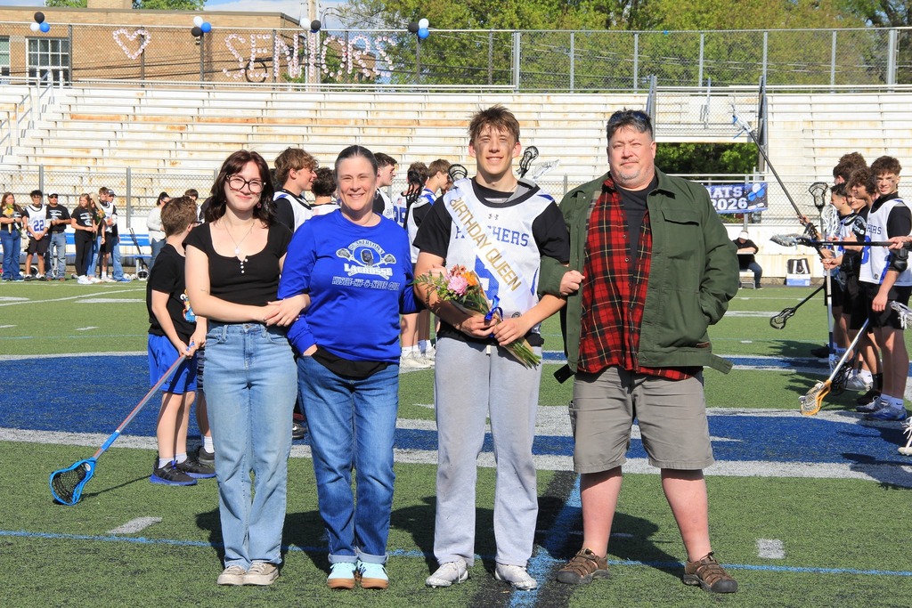 Lucas Gurganus smiles with his family on the field.