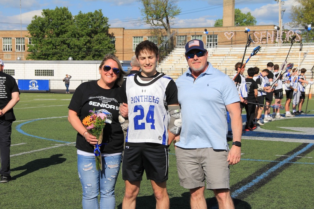 Brady King smiles with his family on the field.