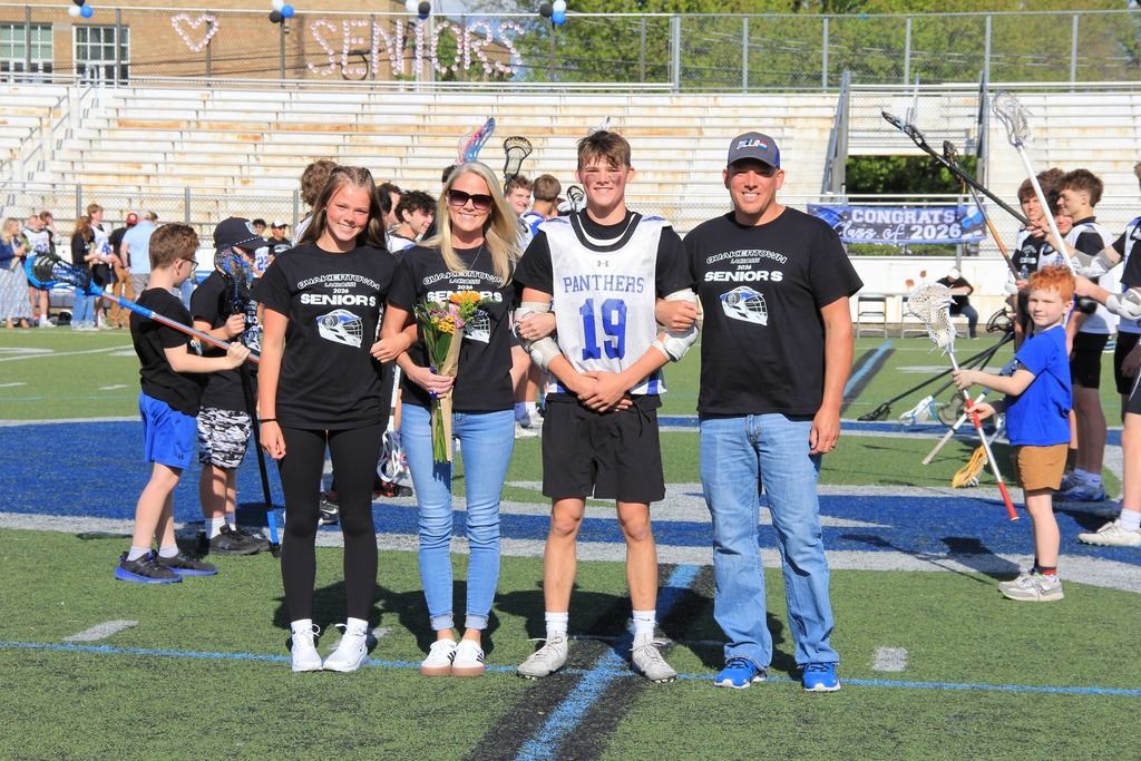 Dillon Thomas smiles with his family on the field.