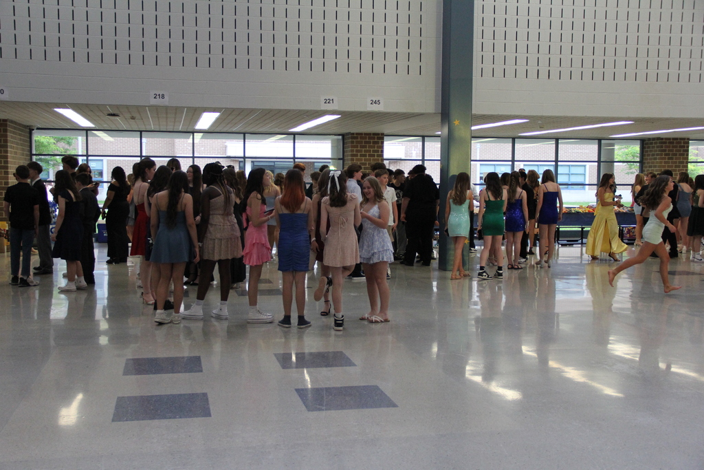 Eighth Grade Dance - students gathered in circles chatting on the dance floor