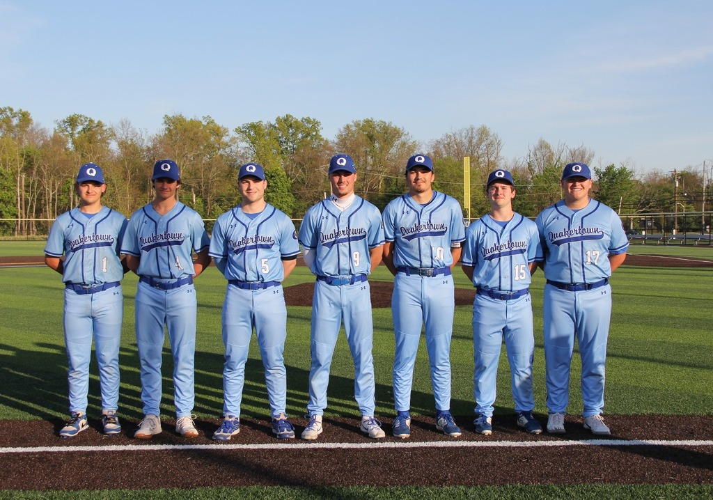 Senior Baseball Players line up for a group photo on the field.