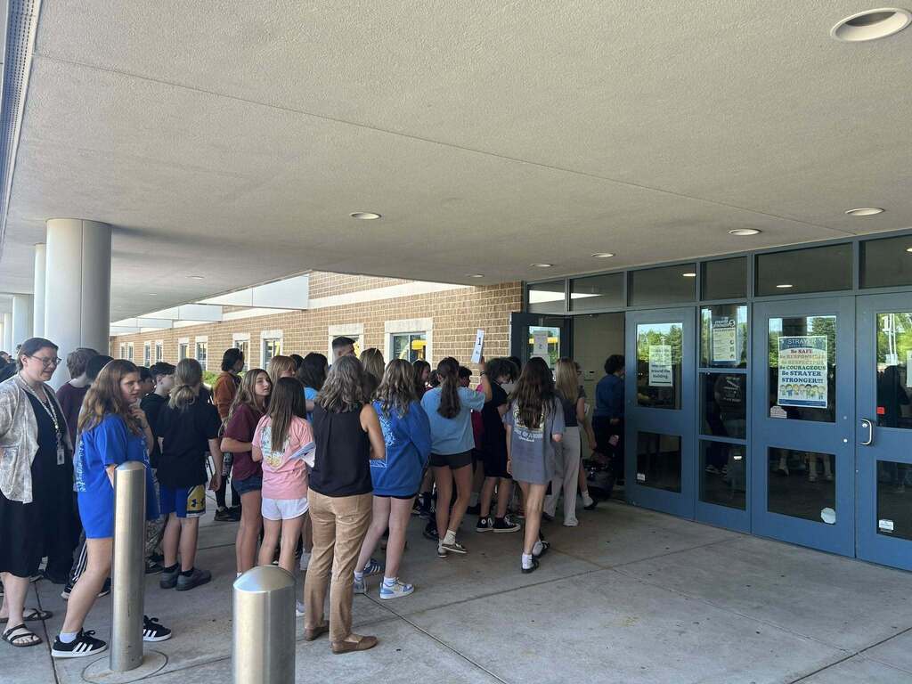 Sixth Grade Students form a line to walk inside of Strayer Middle School