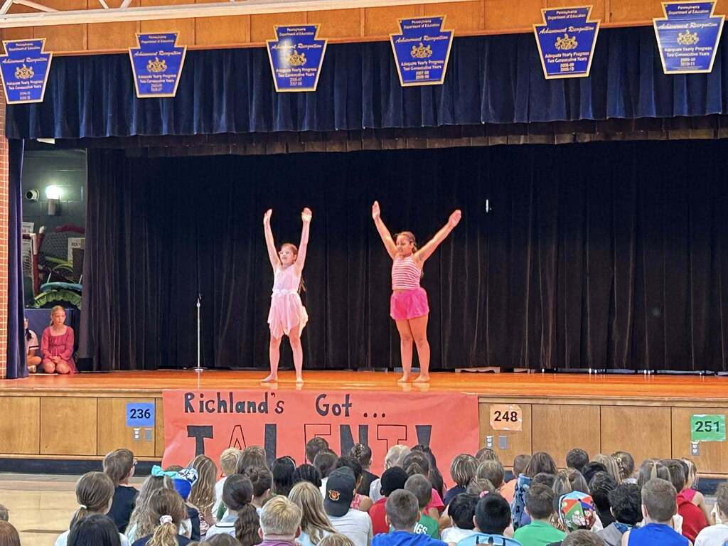 Students perform a dance on the stage of Richland