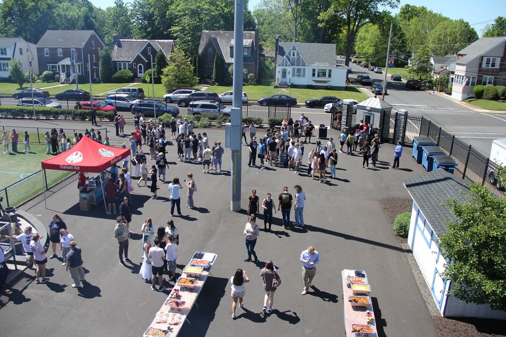 Aerial shot of alumni field and the crowd of seniors entering the picnic