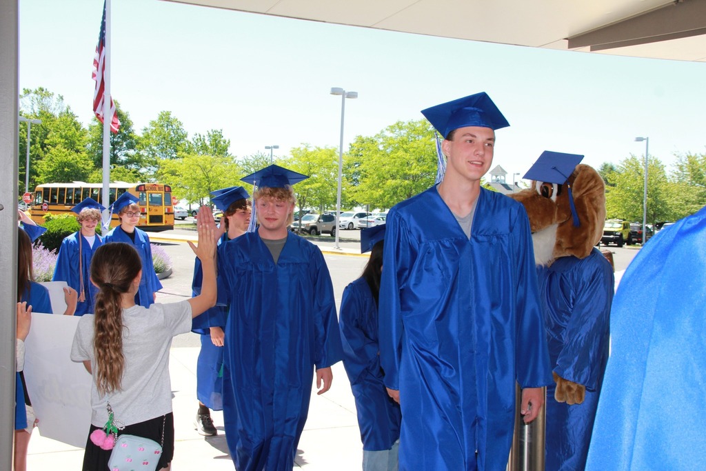 Seniors in their caps and gowns enter Pfaff  Elementary