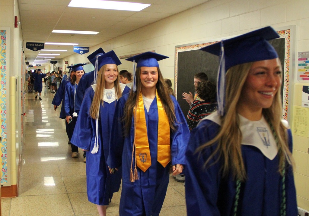 Seniors in their caps and gowns walk the halls of Richland Elementary, as current Richland students cheer them on!