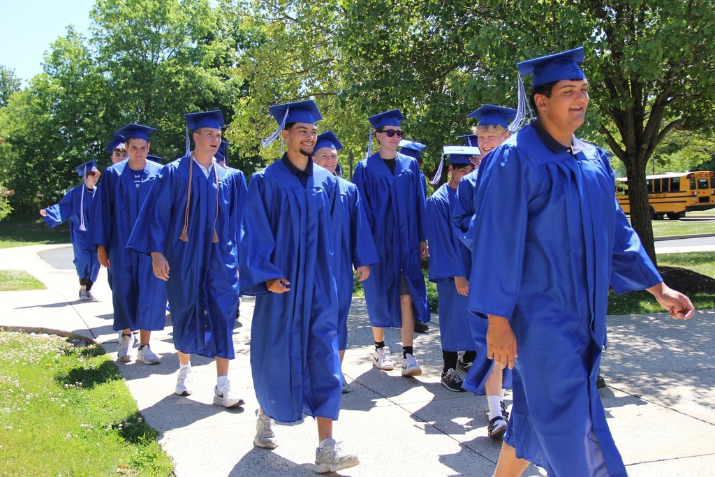 Seniors in their caps and gowns enter Trumbauersville Elementary