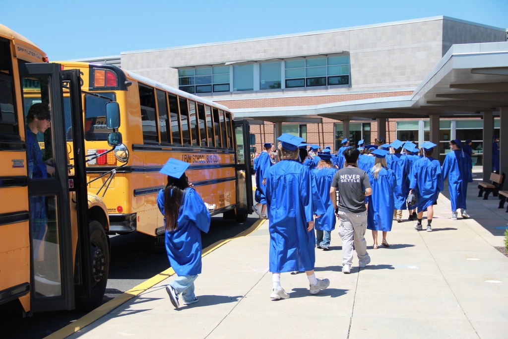 Seniors in their caps and gowns enter Pfaff Elementary