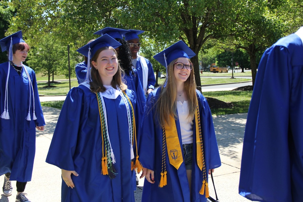 Seniors in their caps and gowns enter Trumbauersville Elementary