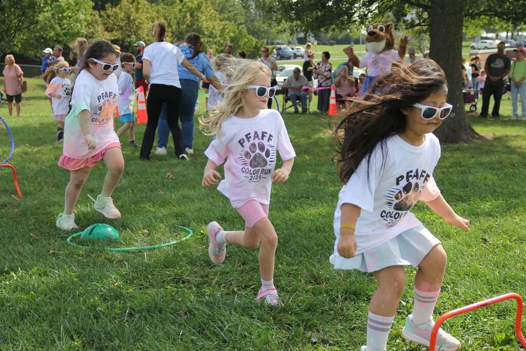 Children running through the grass