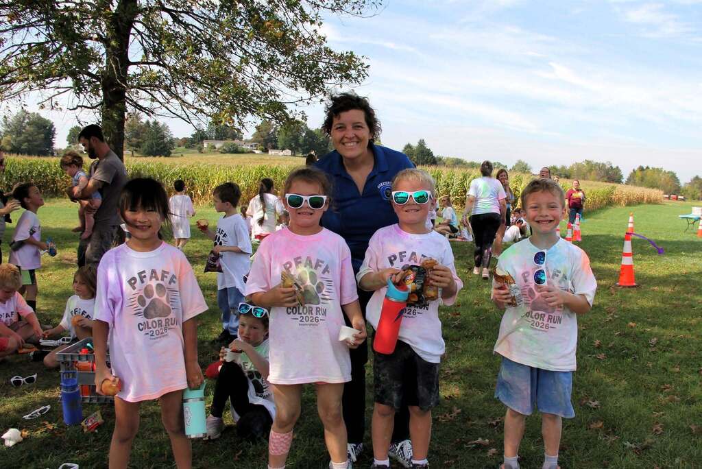 Students smile with Superintendent, Dr. Lisa Hoffman