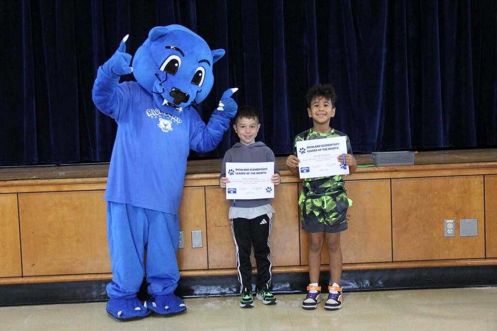 Student Leaders smile with their Leadership Certificates with Richie the Panther Mascot