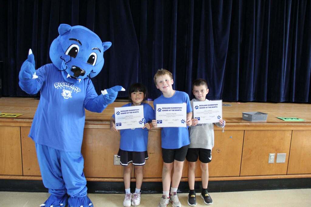 Student Leaders smile with their Leadership Certificates with Richie the Panther Mascot