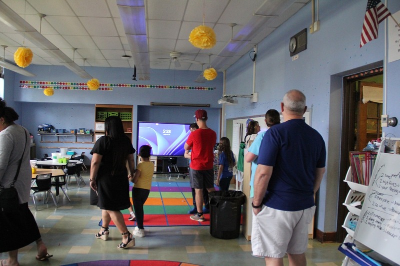 Community members explore classrooms at QE