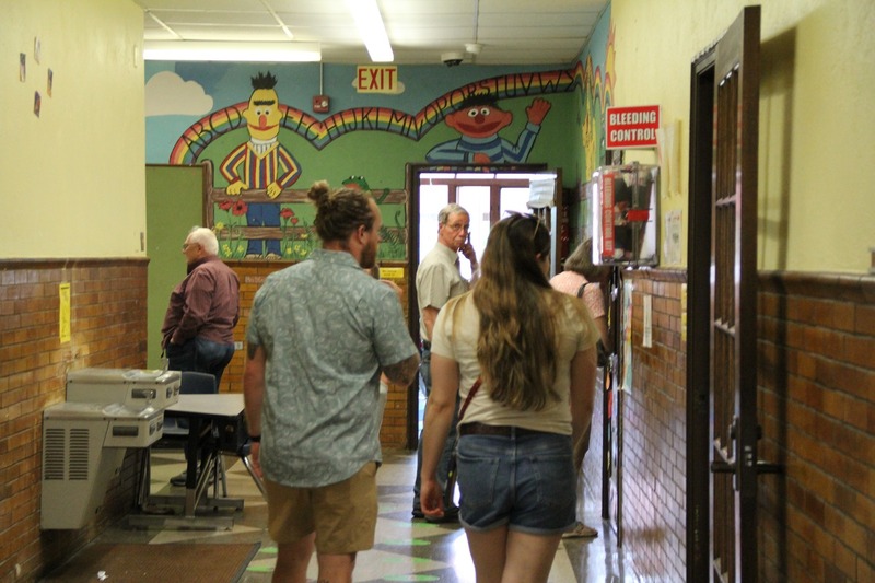 Community members walk the halls of QE