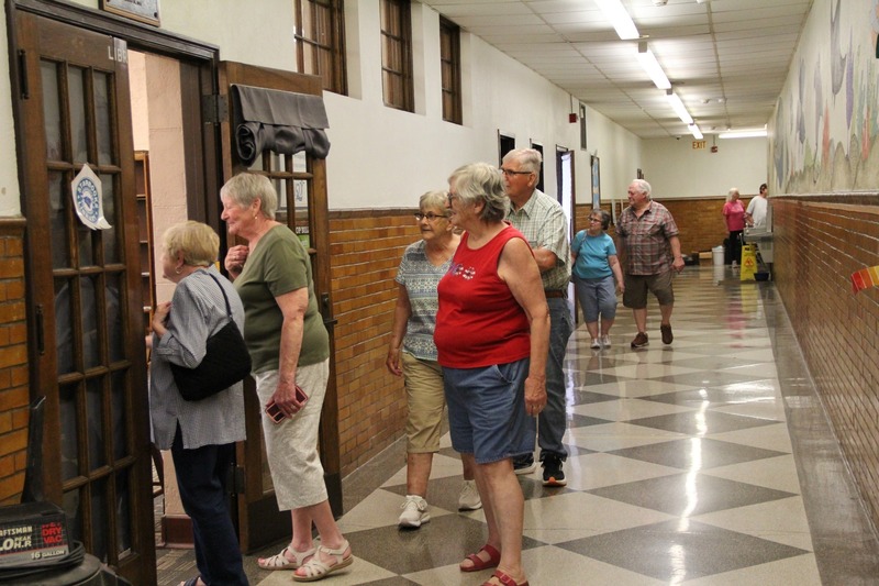Community members walk the halls of QE