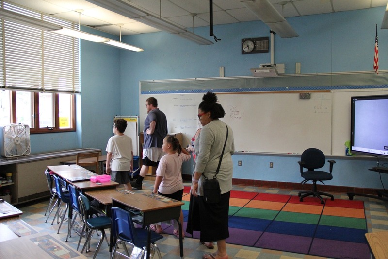 Community members explore classrooms of QE