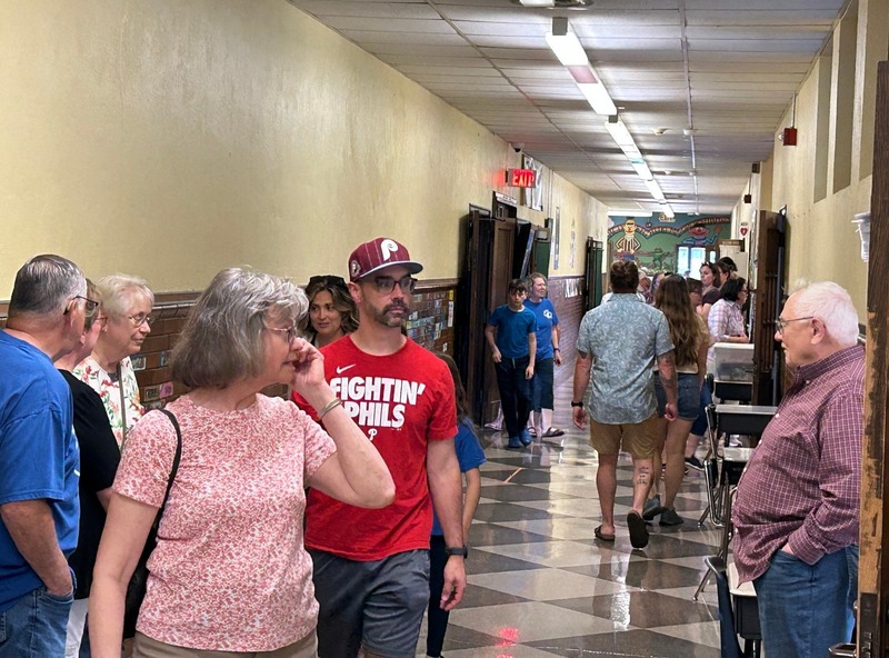 Community members walk the halls of QE