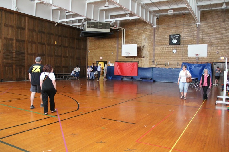Community members walk throughout the gymof QE