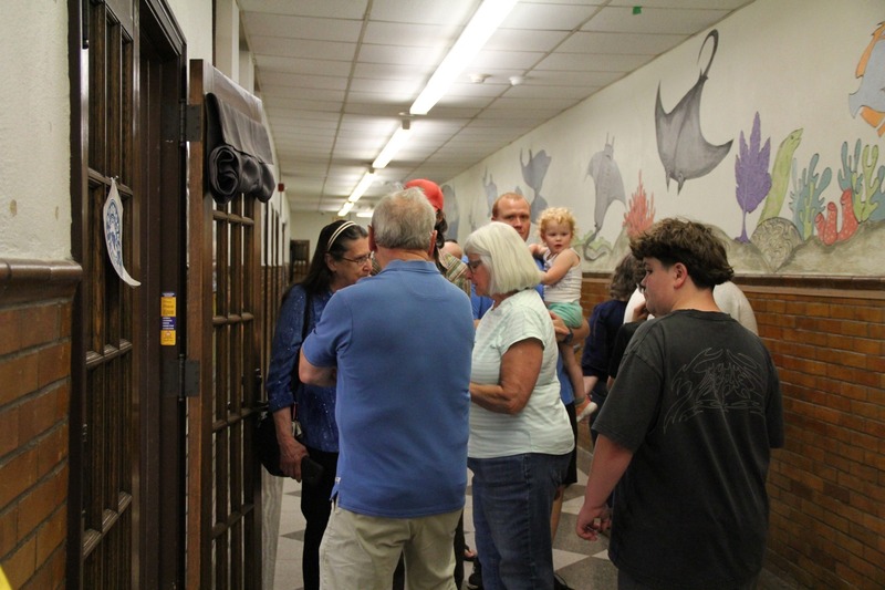 Community members walk the halls of QE