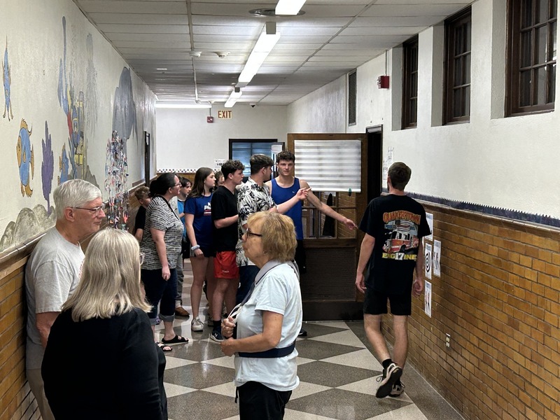 Community members walk the halls of QE