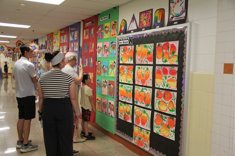 Families admire artwork in the hallways