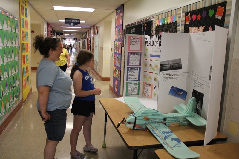 Student and parent admire the presentation on aviation