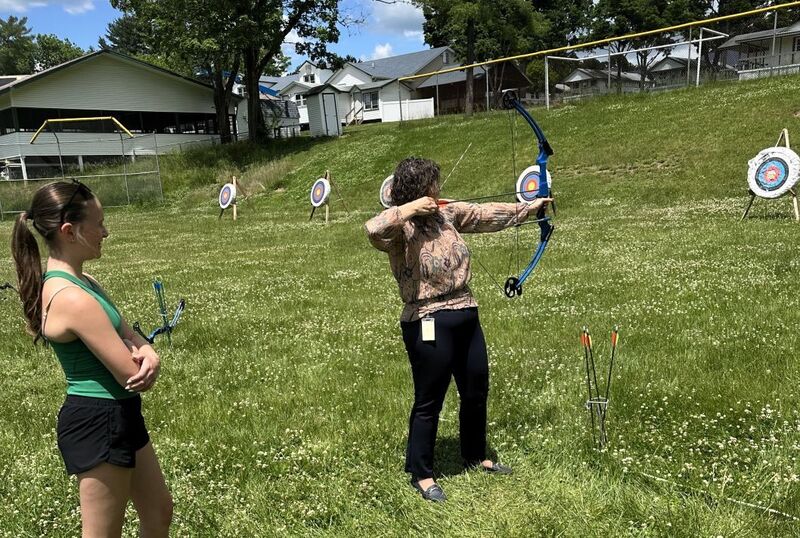 Dr. Hoffman trying out archery
