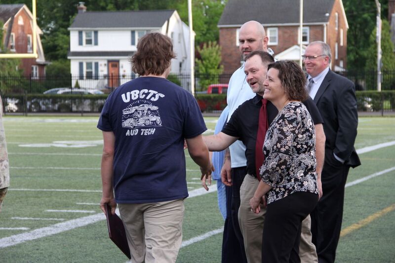 Dr. Hoffman shakes hands with graduates